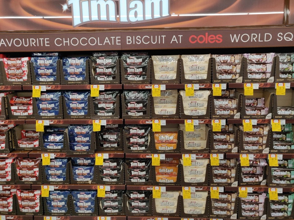 A supermarket shelf stacked floor to ceiling with Tim Tams